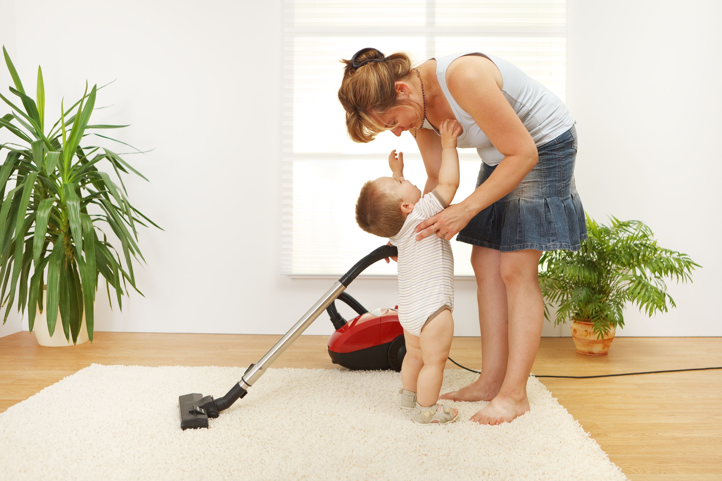 7515583_l-Mother-trying-to-clean-the-floor-while-shes-baby-is-crying-and-wants-to-be-picked-up